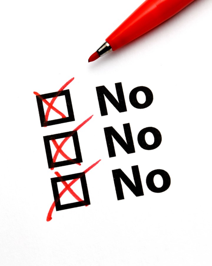 Red Pen and Checklist with Three Checked “No” Boxes on White Paper