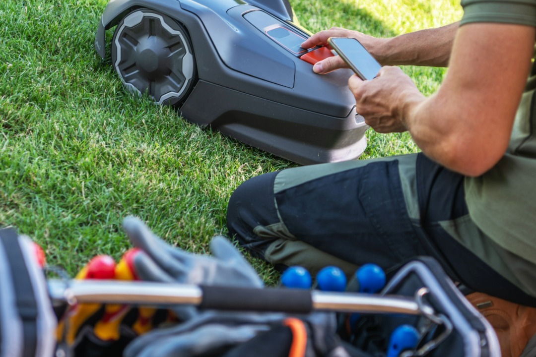 Landscaper operating lawn mower during lawn maintenance setup