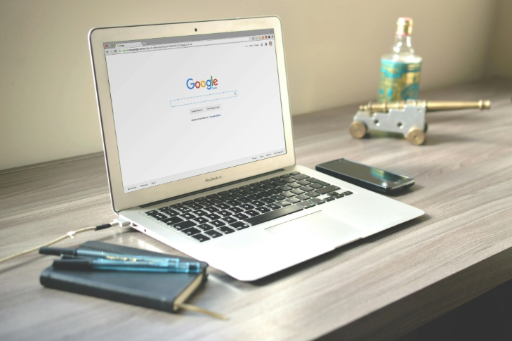 Open laptop with Google search on screen, symbolizing online advertising setup for lawn businesses