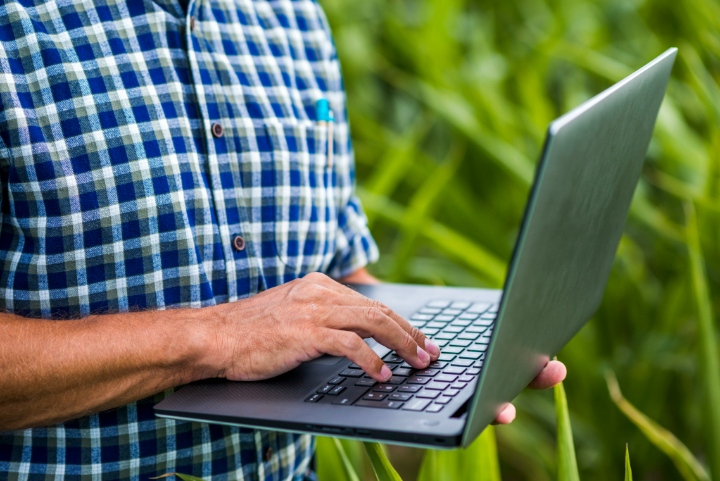 Close-up of a landscaper using a laptop in the field