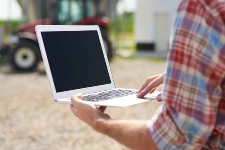 Landscaper Using Laptop During Work At A Lawn