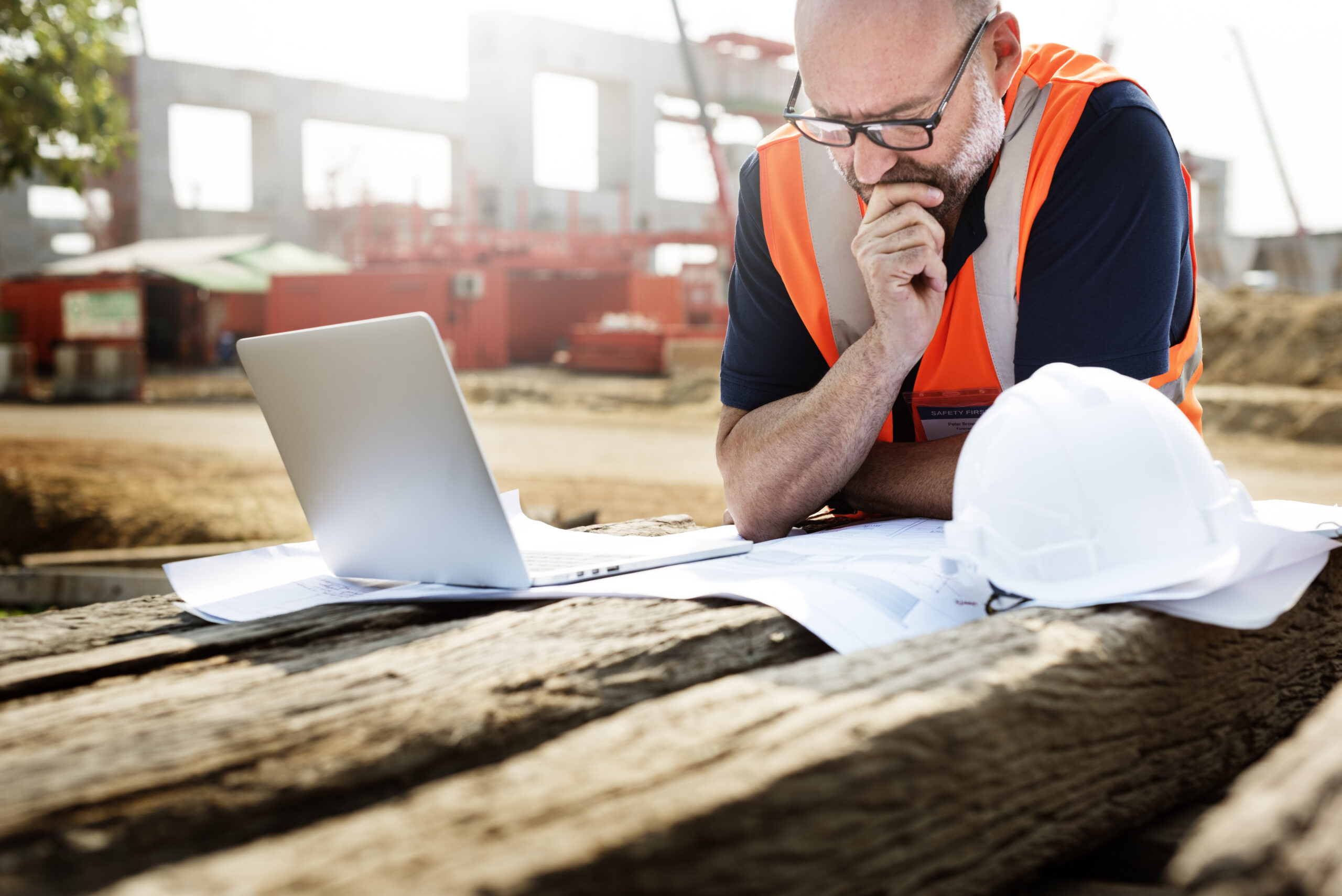 lawn business owner thinking with laptop in front